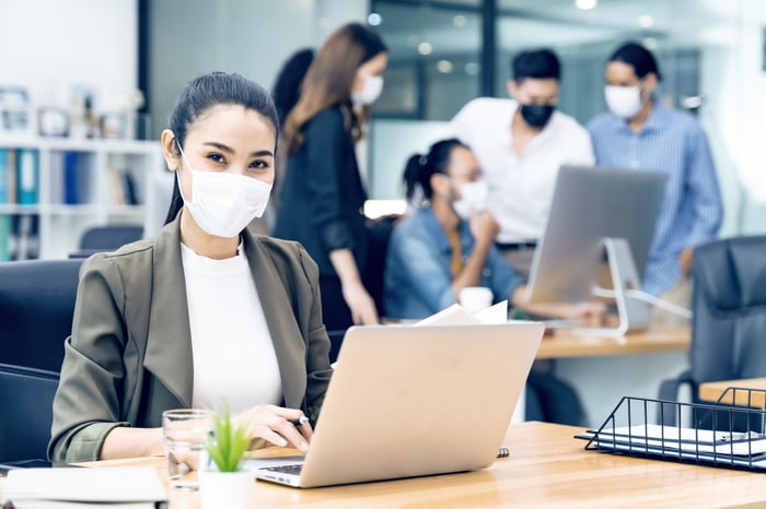 woman working in office with mask