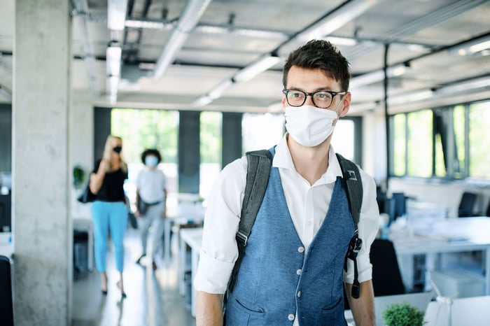 man wears mask in office