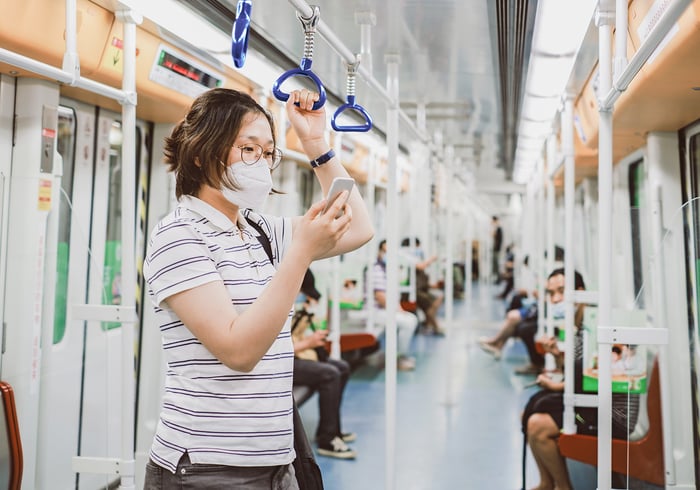 Frau in Metro mit Maske