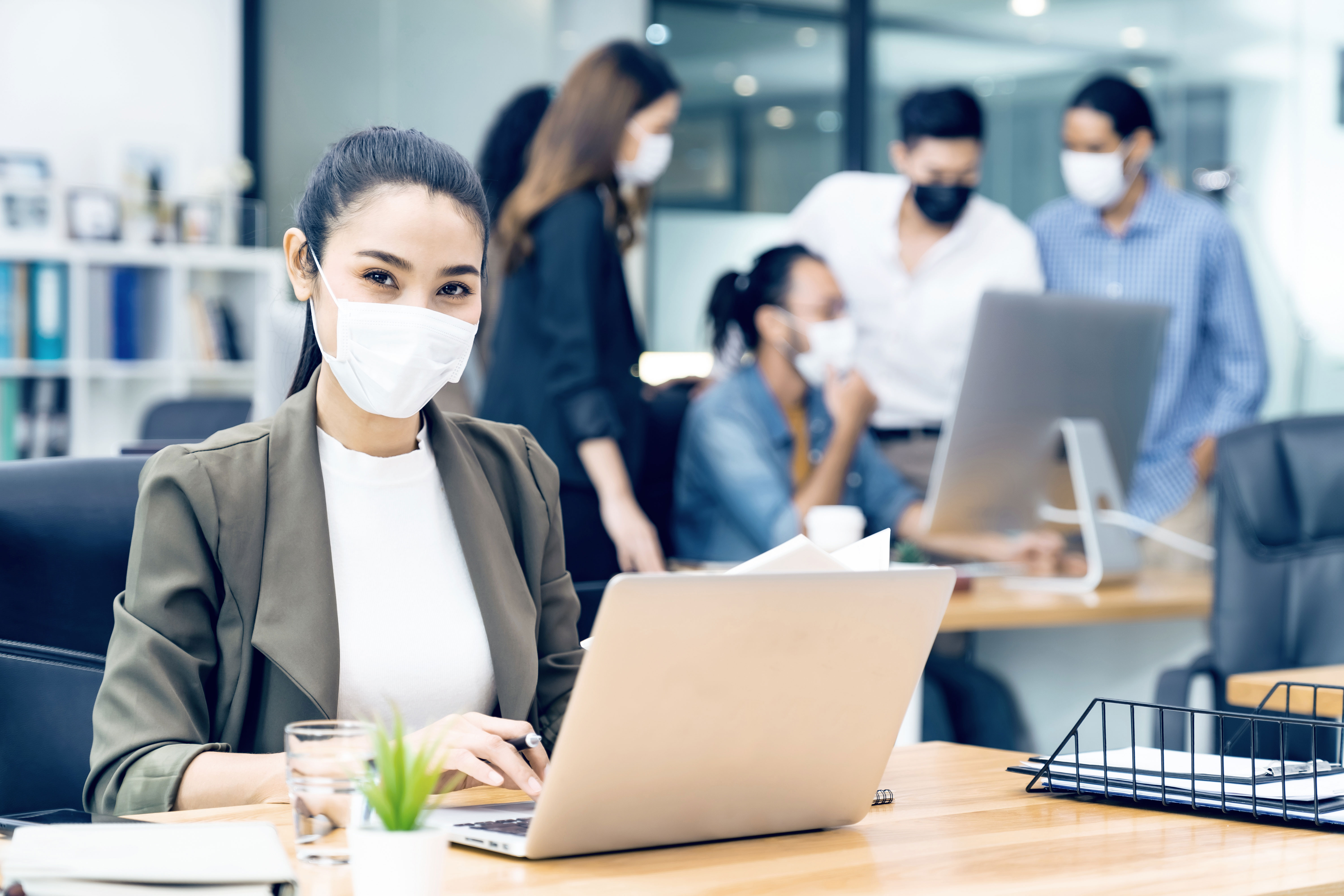 woman working in office with mask